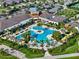 A luxury community pool surrounded by palm trees, lounge chairs, and lush landscaping at 31921 Magna Gulf Loop, San Antonio, FL 33576