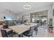 Bright dining room with modern chandelier, table, and chairs next to sliding glass doors and an entertainment center at 31921 Magna Gulf Loop, San Antonio, FL 33576