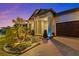 Charming home featuring manicured landscaping and a brick driveway leading to an attached two-car garage at 31921 Magna Gulf Loop, San Antonio, FL 33576