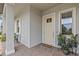 Inviting front porch with neutral paint and brick flooring and an outdoor seating area at 31921 Magna Gulf Loop, San Antonio, FL 33576