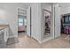 Hallway featuring a full size mirror, coat closet, closet with shelving and an ensuite bedroom at 31921 Magna Gulf Loop, San Antonio, FL 33576