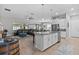 Open-concept kitchen with stainless steel appliances, granite countertops, and a large island at 31921 Magna Gulf Loop, San Antonio, FL 33576
