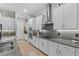 Well-equipped kitchen with white cabinetry, stainless steel appliances, and granite countertops at 31921 Magna Gulf Loop, San Antonio, FL 33576