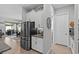 Kitchen area with stainless steel fridge and wood-look flooring at 31921 Magna Gulf Loop, San Antonio, FL 33576