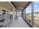 Screened lanai with comfortable seating and a view of the landscaped backyard, offering an ideal outdoor living space at 31921 Magna Gulf Loop, San Antonio, FL 33576