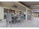 Covered lanai with an outdoor dining area, comfortable seating, and a ceiling fan for enjoying the outdoors at 31921 Magna Gulf Loop, San Antonio, FL 33576