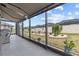 Inviting screened lanai with comfortable seating and views of the landscaped yard, creating a peaceful outdoor retreat at 31921 Magna Gulf Loop, San Antonio, FL 33576