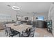 Open-concept living space featuring a dining area, kitchen with bar seating, and living room with large sectional at 31921 Magna Gulf Loop, San Antonio, FL 33576