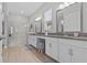 Luxurious main bathroom with double sinks, granite counters, and glass enclosed shower at 31921 Magna Gulf Loop, San Antonio, FL 33576