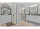 Bright main bathroom featuring dual vanities, granite countertops, a glass enclosed shower, and ample storage at 31921 Magna Gulf Loop, San Antonio, FL 33576