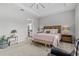 Bright and airy main bedroom with a cozy seating area, a bench, and a walk-in closet at 31921 Magna Gulf Loop, San Antonio, FL 33576