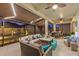 Inviting screened-in patio with ample seating and ceiling fans, perfect for entertaining or relaxing at 31921 Magna Gulf Loop, San Antonio, FL 33576