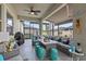 Screened patio featuring outdoor couch, stools and dining area at 31921 Magna Gulf Loop, San Antonio, FL 33576