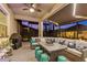 Inviting screened-in patio with comfortable seating, a large table, and atmospheric lighting for relaxing evenings at 31921 Magna Gulf Loop, San Antonio, FL 33576