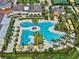 Aerial view of a resort-style pool surrounded by palm trees and lounge chairs in a Primary-planned community at 31921 Magna Gulf Loop, San Antonio, FL 33576
