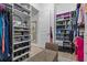 Custom walk-in closet with shelving, drawers, and a leopard print bench, adjacent to a bathroom for convenience at 31921 Magna Gulf Loop, San Antonio, FL 33576