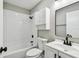 This bathroom features modern cabinets, black hardware, a tiled shower and a modern sink, toilet and cabinets at 3515 41St S Ter # 224, St Petersburg, FL 33711