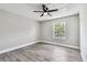 This bedroom features modern gray floors, light gray walls, a black ceiling fan and a window with a view at 3515 41St S Ter # 224, St Petersburg, FL 33711