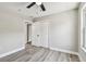 This bedroom features modern gray floors, light gray walls, white trim, closet and access to the bathroom at 3515 41St S Ter # 224, St Petersburg, FL 33711