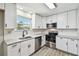 Modern kitchen with white cabinets, stainless steel appliances, and granite countertops at 3515 41St S Ter # 224, St Petersburg, FL 33711