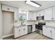 Modern kitchen with white cabinets, stainless steel appliances, and granite countertops at 3515 41St S Ter # 224, St Petersburg, FL 33711