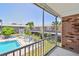 This screened patio offers clear views of the community pool, lounging area, and lush tropical landscaping at 3515 41St S Ter # 224, St Petersburg, FL 33711