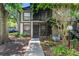 Inviting two-story condo featuring a covered porch and well-maintained landscaping at 4004 Dream Oak Pl # 102, Tampa, FL 33613