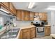 Well-maintained kitchen featuring wood cabinetry and stainless steel appliances at 4004 Dream Oak Pl # 102, Tampa, FL 33613