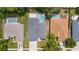 Aerial view of houses with pools and well-manicured lawns in a residential neighborhood at 403 Carriage House Ln, Tarpon Springs, FL 34688