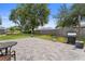Inviting backyard with a paved patio area and manicured lawn and trees. Perfect for entertaining at 403 Carriage House Ln, Tarpon Springs, FL 34688