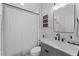 Classic bathroom featuring a shower with curtain, stylish vanity, and modern fixtures at 403 Carriage House Ln, Tarpon Springs, FL 34688