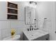 Stylish bathroom featuring marble countertop, modern black faucet, and decorative wall signs at 403 Carriage House Ln, Tarpon Springs, FL 34688