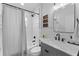 Classic bathroom featuring a shower with curtain, stylish vanity, and modern fixtures at 403 Carriage House Ln, Tarpon Springs, FL 34688