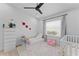 Bright Bedroom with a cozy toddler bed, crib, and a window offering natural light at 403 Carriage House Ln, Tarpon Springs, FL 34688