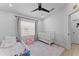 Bright Bedroom with a crib, toddler bed and a comfy pink chair. Hardwood floors at 403 Carriage House Ln, Tarpon Springs, FL 34688