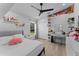 Bright bedroom with shelves full of decorations and a comfortable bed at 403 Carriage House Ln, Tarpon Springs, FL 34688