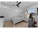 Comfortable bedroom features a ceiling fan, closet, and exercise equipment at 403 Carriage House Ln, Tarpon Springs, FL 34688