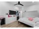 Modern bedroom features a television, dresser, and cozy bed at 403 Carriage House Ln, Tarpon Springs, FL 34688