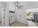 Inviting front entry featuring wood floors, a stylish pendant light, and convenient storage furniture at 403 Carriage House Ln, Tarpon Springs, FL 34688