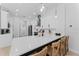 Modern kitchen with a black island, white countertops, and seating for guests at 403 Carriage House Ln, Tarpon Springs, FL 34688
