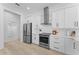 Contemporary kitchen features white cabinets, stainless appliances, and ample counter space at 403 Carriage House Ln, Tarpon Springs, FL 34688
