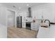 Modern kitchen features white cabinets, stainless steel appliances, and sleek hardware at 403 Carriage House Ln, Tarpon Springs, FL 34688