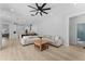 Spacious living room flows into a kitchen with a breakfast bar and a nearby bathroom at 403 Carriage House Ln, Tarpon Springs, FL 34688