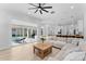 Bright living room with sliding doors leading to an outdoor patio with a pool at 403 Carriage House Ln, Tarpon Springs, FL 34688