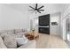 Bright living room with modern fireplace, ceiling fan, and sliding glass doors to outdoor living at 403 Carriage House Ln, Tarpon Springs, FL 34688