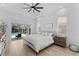 Tranquil main bedroom with pool view through sliding doors, ceiling fan, and decorative art at 403 Carriage House Ln, Tarpon Springs, FL 34688
