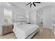 Bright main bedroom with natural light from windows, ceiling fan, and tray ceiling at 403 Carriage House Ln, Tarpon Springs, FL 34688