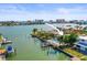 Waterfront home featuring a pool and dock with boat lift, offering stunning views and direct access to the water at 403 Normandy Rd, Madeira Beach, FL 33708