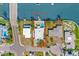 Drone shot showcasing a waterfront home with a pool, boat dock, and easy street access in a coastal community at 403 Normandy Rd, Madeira Beach, FL 33708