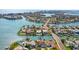 Panoramic aerial showcasing the waterfront community with numerous canals, homes, and stunning views of the open ocean at 403 Normandy Rd, Madeira Beach, FL 33708
